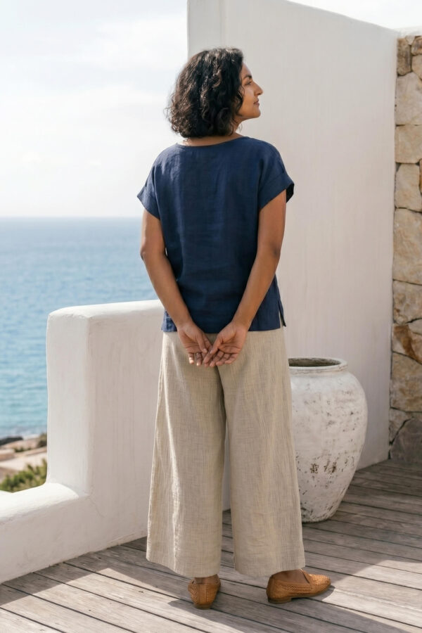 Mujer vistiendo blusa de lino azul marino y pantalon de lino avena estilo slow living