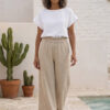 Mujer vistiendo blusa blanca de lino y pantalon de lino avena para clima calido