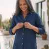 Mujer vistiendo blusa de lino azul marino y pantalon de lino blanco para clima calido