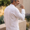 Hombre vistiendo camisa blanca de manga larga y cuello Mao en lino natural